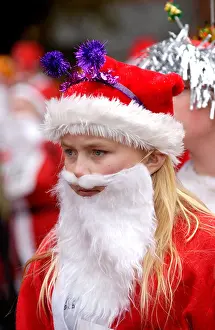 Eccentric Prints: Young woman dressed as Santa Claus for the annual charity Santa Fun Run at Newtown Powys Wales UK