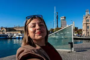 Selfie Prints: Young woman enjoying selfie at port of barcelona