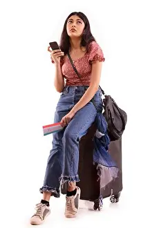 20 25 Years Prints: A young woman with an exhausted expression booking an online travel ticket on mobile phone