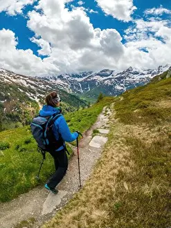 Salzburg Prints: Young woman hiking on footpath in the Austrian Alps near Gastein, Salzburg, Austria