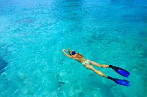 Miami Prints: Young woman ig snorkeling in tropical lagoon