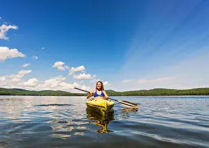 20 24 Years Prints: Young woman kayaking on lake