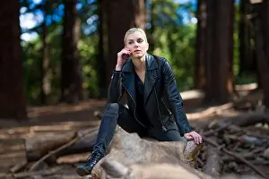 Forest Floor Prints: Young woman on large fallen redwood log in redwood grove