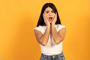 Shocked Prints: Young woman with long dark hair covering her face with hands
