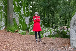 Boulders Prints: Young woman lost on a forest shivering with cold and embracing or holding herself