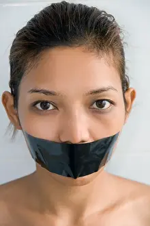 Young woman with mouth sealed