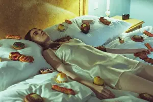 Sublimation Prints: young woman in silk nightie lying on bed with many candies