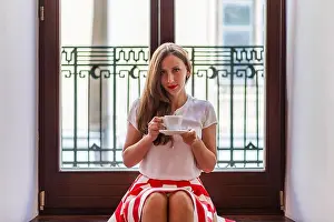 Skirt Prints: A young woman sits on a balcony steps