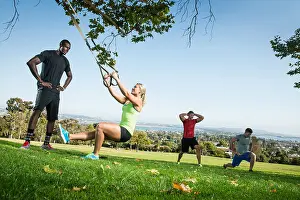 Face To Face Prints: Young woman and trainer with lunge rope in field