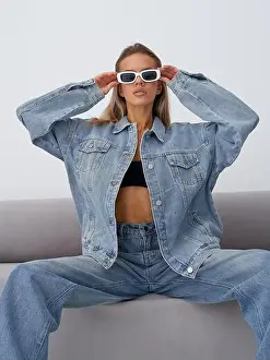 Vogue Prints: Young woman wearing large denim jacket and jeans