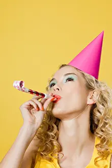 Curly Hair Prints: Young woman wearing party hat with party blower