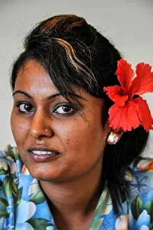 A young woman wearing a Red Hibiscus - a native flower of Fiji in the South Pacific Half of Fiji's population are of Asian decent