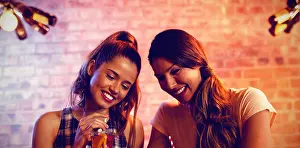 Real Life Prints: Two young women using mobile phone