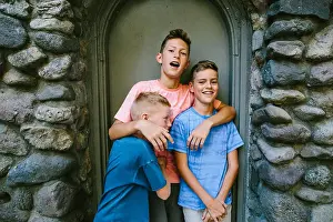 Siblings Prints: Youngest brother playfully punches older brother in stomach
