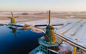 Cold Weather Prints: Zaanse Schans windmill village during winter with snow landscape in the Netherlands Holland village in winter