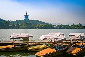 Zhejiang Prints: Zhejiang, China - 01 November 2017: Leifeng Pagoda with sightseeing boats at West Lake